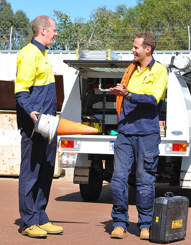 Two Electricians Having A Chat